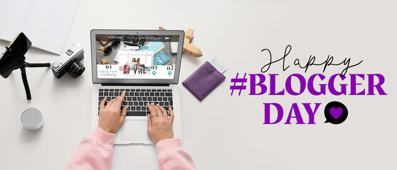 Female travel blogger using laptop on table, top view