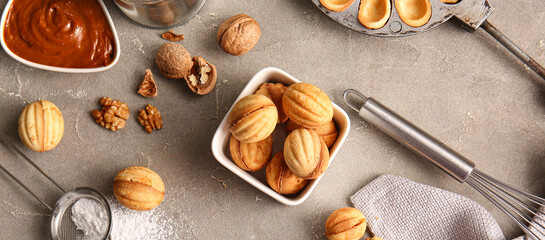 Composition with tasty walnut shaped cookies and ingredients on grunge background