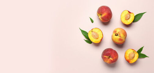 Sweet peaches and leaves on beige background