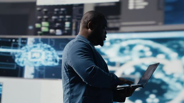 Black IT engineer working in a digital environment with programming language and data science algorithm. Specialist reviews code development, automation and innovation. Coding life. Camera B.