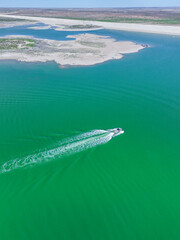 aerial view of tropical island with boat and deep blue water