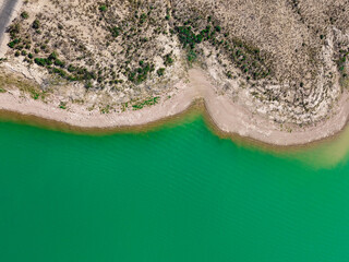 aerial view of river in deep green with desert landscape in new mexico