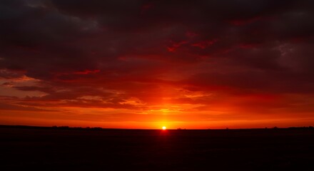 Obraz premium Fiery Red Sunrise Sky with Dark Clouds - Dramatic Dawn Landscape