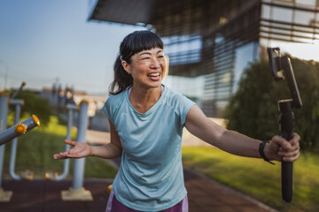 Japanese woman blogger record video for v-log and show outdoor gym