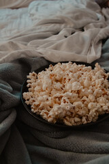 Popcorn in Bowl on a Cozy Bed
