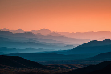 Fototapeta premium Mountain Layered Mountains at Serene Sunrise, Hazy Morning Vista