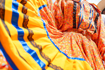 Close-up of colombian dancer wearing traditional colorful dress is performing