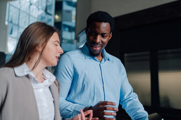 Business colleagues collaborating, sharing ideas in office environment