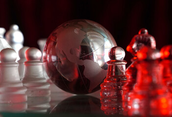 Crystal planet Earth amidst chess pieces showing the American continent, representing concepts of geopolitics, global power, competition for control, international relations, world leaders, struggle f