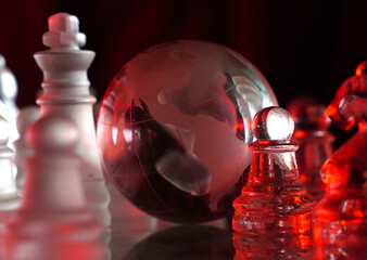 Crystal planet Earth amidst chess pieces showing the American continent, representing concepts of geopolitics, global power, competition for control, international relations, world leaders, struggle f