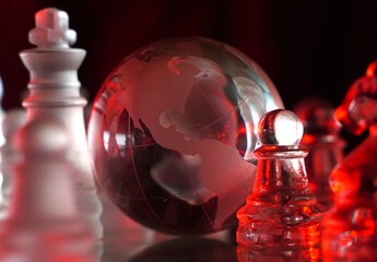 Crystal planet Earth amidst chess pieces showing the American continent, representing concepts of geopolitics, global power, competition for control, international relations, world leaders, struggle f