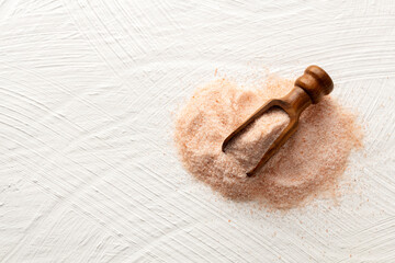 Fine pink Himalayan salt in a spoon - Pakistani red rock salt