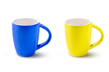Two cups of blue and yellow coffee isolated on white
