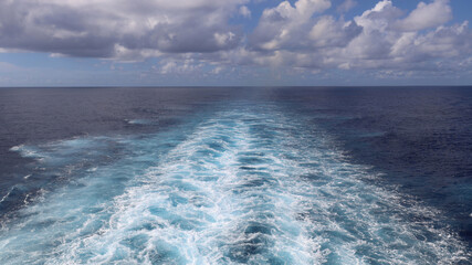 Ocean perspective behind sailing cruise ship