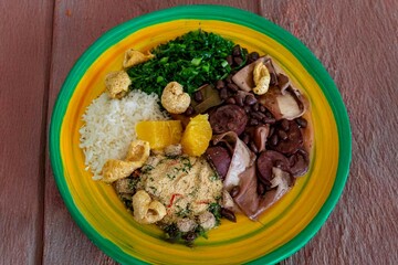 The best traditional Brazilian feijoada completely served in the most authentic style accompanied by the irresistible and iconic cachaça caipirinha