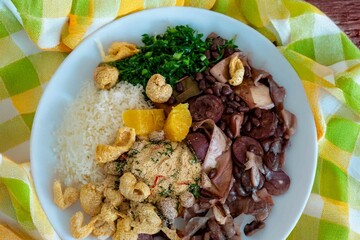 The best traditional Brazilian feijoada completely served in the most authentic style accompanied by the irresistible and iconic cachaça caipirinha