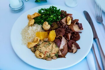 The best traditional Brazilian feijoada completely served in the most authentic style accompanied by the irresistible and iconic cachaça caipirinha