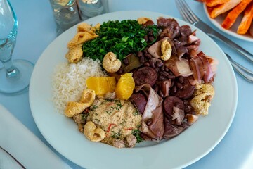 The best traditional Brazilian feijoada completely served in the most authentic style accompanied by the irresistible and iconic cachaça caipirinha