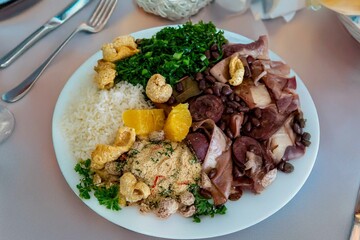 The best traditional Brazilian feijoada completely served in the most authentic style accompanied by the irresistible and iconic cachaça caipirinha