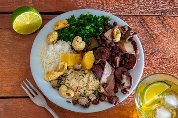 The best traditional Brazilian feijoada completely served in the most authentic style accompanied by the irresistible and iconic cachaça caipirinha