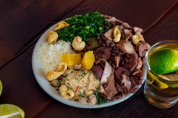 The best traditional Brazilian feijoada completely served in the most authentic style accompanied by the irresistible and iconic cachaça caipirinha
