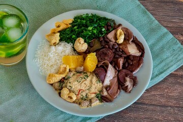 The best traditional Brazilian feijoada completely served in the most authentic style accompanied by the irresistible and iconic cachaça caipirinha
