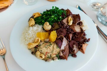 The best traditional Brazilian feijoada completely served in the most authentic style accompanied by the irresistible and iconic cachaça caipirinha