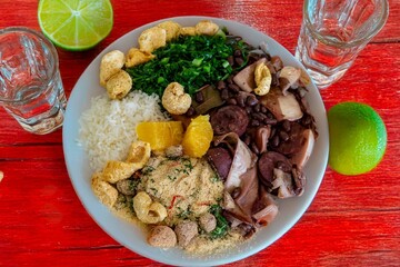 The best traditional Brazilian feijoada completely served in the most authentic style accompanied by the irresistible and iconic cachaça caipirinha
