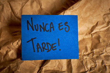 Inspirational Spanish phrase It’s never too late written by hand 