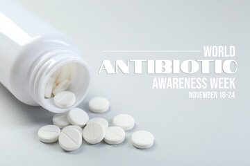 World antibiotic awareness week. Bottle and scattered pills on light background