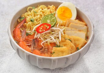 Laksa is a spicy noodle soup popular in the Peranakan cuisine of Southeast Asia. Laksa consists of thick wheat noodles or rice vermicelli with chicken, prawn or fish, served in spicy soup.