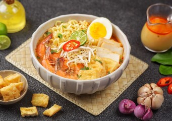 Laksa Singapore is a spicy noodle soup popular in the Peranakan cuisine of Southeast Asia. Laksa consists of thick wheat noodles or rice vermicelli with chicken, prawn or fish, served in spicy soup.