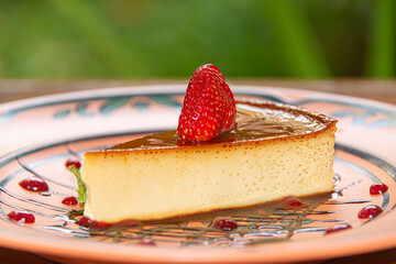 Napolitan Flan with Strawberry on Clay Plate in Colonial Restaurant