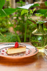 Napolitan Flan with Strawberry on Clay Plate in Colonial Restaurant