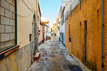 A narrow residential alley through the winding historic old town district under the Moorish Castle...