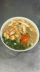 Indonesian chicken soto or soto ayam served with white rice, Indonesian traditional chicken soup