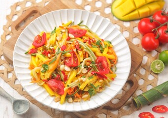 Spicy Thai Mango Salad featuring fresh flavors of cucumber, carrot and cilantro spicy, sweet and savory dressing.