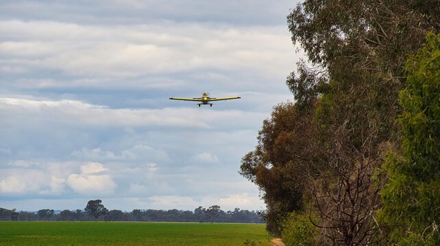 Crop duster flying low over farmland near Yarrawonga