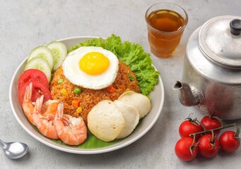 Nasi Goreng. Fried rice is a dish of rice fried in a wok or frying pan which produces a different taste because it is mixed with spices such as salt, garlic, shallots, pepper, certain spices.