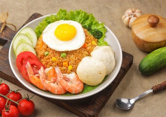 Nasi Goreng. Fried rice is a dish of rice fried in a wok or frying pan which produces a different taste because it is mixed with spices such as salt, garlic, shallots, pepper, certain spices.