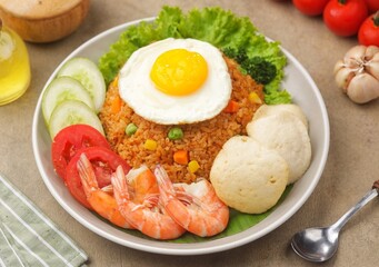 Nasi Goreng. Fried rice is a dish of rice fried in a wok or frying pan which produces a different taste because it is mixed with spices such as salt, garlic, shallots, pepper, certain spices.