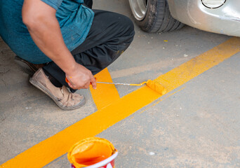 Workers are repainting the parking space markings.