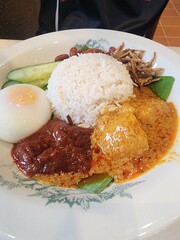 Traditional Malaysian Nasi Lemak with Rendang, Sambal, and Soft-Boiled Egg