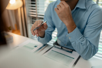 the company's auditing staff is checking the documents for accuracy in the office, businessman is...