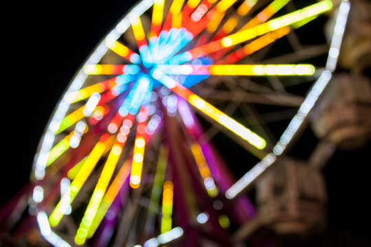 Colorful Ferris Wheel Lit up at Night Blurry