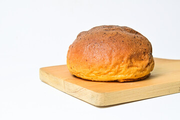 Close up view of choco bun on wooden cutting board isolated on white background. clipping path, baked, brown.