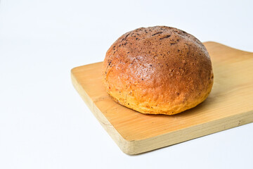Close up view of choco bun on wooden cutting board isolated on white background. clipping path,...
