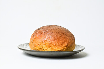 Side view of choco bun on little white and black plate isolated on white background. clipping path,...