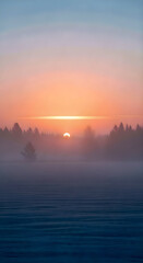 Majestic sunset over a frozen field evokes a sense of stillness and the beauty of winter's embrace.