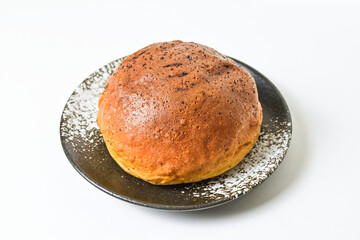 Close up view of choco bun on little white and black plate isolated on white background. clipping...